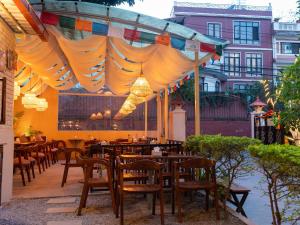 a restaurant with tables and chairs under a canopy at Yangchen Home Hotel in Kathmandu