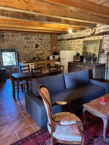 a living room with a blue couch and a table at La maison de Baptiste La Monédière in Chaumeil