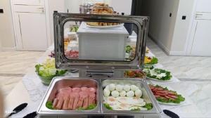 a buffet with meat and vegetables on a table at Luna Plaza Hotel in Lunacharskiy Bekati +13 photos