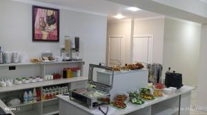 a kitchen with a counter with food on it at Luna Plaza Hotel in Lunacharskiy Bekati