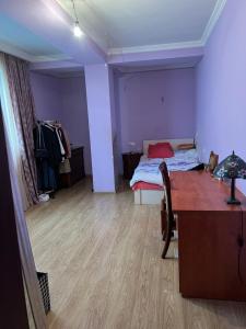 a room with a bed and a desk and a room with a desk at Big Flat in Tbilisi City