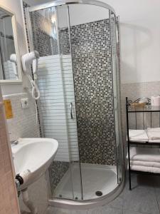 a bathroom with a shower and a sink at Hotel Ristorante Sassi Rossi in Taceno +34 photos