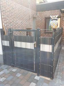 a black gate with a window in a brick building at Ferienwohnung Emma in Marl +5 photos