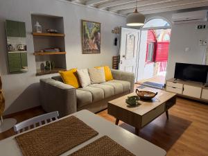 a living room with a couch and a table at The Wine House in Chios