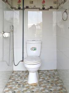 a white toilet in a bathroom with a shower at Mama Pham Homestay in Tả Van +12 photos