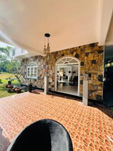 a room with a stone wall and a large mirror at Benthota grand villa in Nakandalagoda