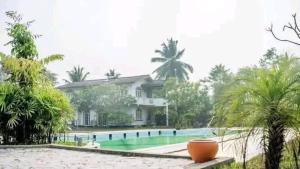 a house with a swimming pool in front of it at Benthota grand villa in Nakandalagoda