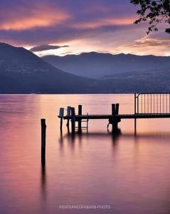 a dock in the middle of a body of water at BINARIO 16- new loft in Marone