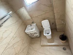 a bathroom with a toilet and a sink at Sundervan Resort in Alwar +33 photos