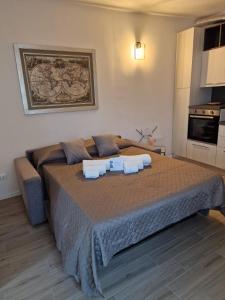 a bedroom with a large bed with two towels on it at BINARIO 16- new loft in Marone