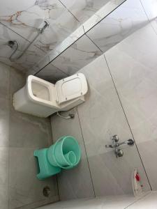 a bathroom with a toilet and a mirror on the wall at Sundervan Resort in Alwar