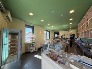 a bakery with a counter with food on display at Casa Makeda in Rosate +12 photos