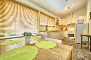 a kitchen with a table with green plates on it at Spencer Suites Albany in Albany