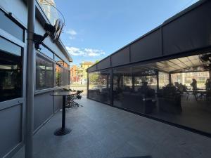 a building with a patio with tables and chairs at Casa Makeda in Rosate