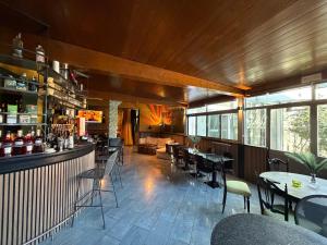 a restaurant with tables and chairs and a bar at Casa Makeda in Rosate