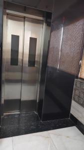 a pair of elevator doors in a building at Hotel Ravi Palace Agra in Agra