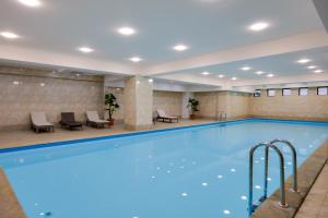 a large swimming pool in a hotel room at Hotel Astoria Tbilisi in Tbilisi City