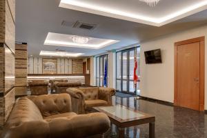 a living room with a couch and a table at Hotel Astoria Tbilisi in Tbilisi City