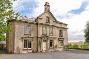 an old brick house with a tower on top at Garden Flat- Private Luxury in Ashkirk