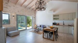 a kitchen and living room with a table and chairs at Lucié in Argyrátika +19 photos