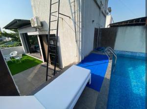 a small swimming pool with a ladder next to a building at Sunleaf Palace in Pune