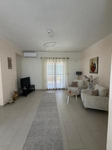 a living room with a couch and a tv at Panoramic Krujë Escape BAMI in Krujë