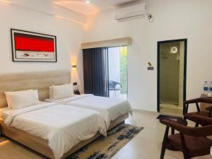 a bedroom with a large bed and a window at Kokomo Sunset Resort in Gazipur +43 photos