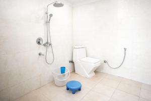 a bathroom with a shower and a toilet in it at Mauryan Express I Hotel Malviya Nagar in New Delhi