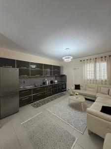 a living room with a couch and a kitchen at Panoramic Krujë Escape BAMI in Krujë