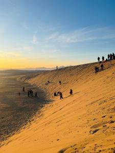 a group of people on a sandy beach at Mongolian Nomadic Herders in Dörgön