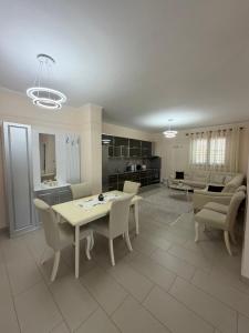 a kitchen and living room with a table and chairs at Panoramic Krujë Escape BAMI in Krujë +14 photos