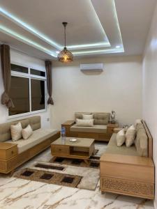 a living room with two couches and a table at Dar Tozeur in El Oudiane-Degache