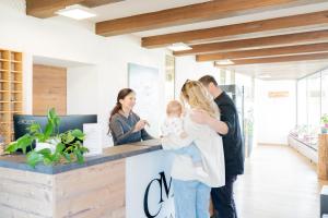 a family standing at a counter in a house at Hotel Casa Maria in Halblech