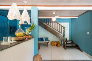 a kitchen with blue walls and a staircase at Hotel do Pescador in Morro de São Paulo