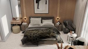 a bedroom with a large bed and a chair at IDEA Collection by GINO Hotels in Tbilisi City +38 photos