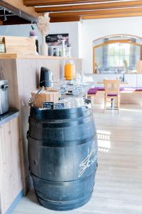 a large barrel sitting in a room with a table at Hotel Casa Maria in Halblech