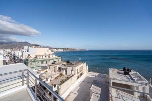 a view of the ocean from the balcony of a building at Notos Horizon in Ierapetra