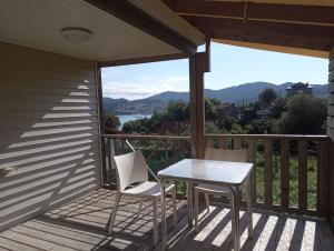 a table and two chairs on a deck with a view at CCA area in Hio