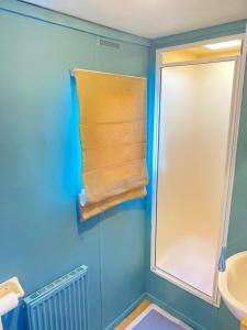 a bathroom with a window and a towel at PD Wonderwall Caravan, Direct beach access & Beds made on arrival & GCH in Ingoldmells +16 photos