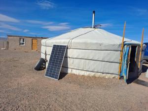 a tent with a solar panel on the side of it at Mongolian Nomadic Herders in Dörgön