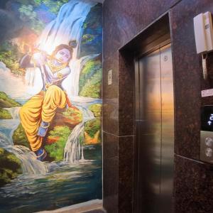 a mural of a woman on a waterfall in an elevator at UK Comforts in Bangalore +39 photos