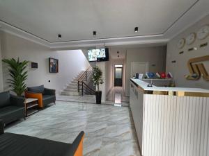 a large living room with a lobby with a staircase at Luna Plaza Hotel in Lunacharskiy Bekati