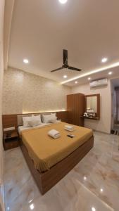 a bedroom with a bed with two towels on it at UK Comforts in Bangalore