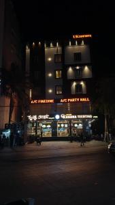 a large apartment building with a party hall at night at UK Comforts in Bangalore