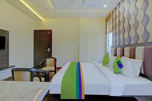 a bedroom with a large bed with a colorful blanket at Hotel Taj Venture Agra in Agra