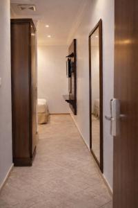 a hallway with a door and a mirror in a room at Carawan Al Khaleej Hotel Olaya in Riyadh