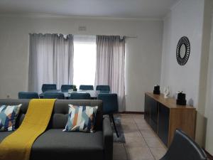 a waiting room with chairs and a couch and a table at Five-Bedroom House at 27 Baobab Avenue, Birchleigh, Kempton Park, Backup Power Supply in Kempton Park