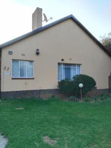 a house with a green lawn in front of it at Five-Bedroom House at 27 Baobab Avenue, Birchleigh, Kempton Park, Backup Power Supply in Kempton Park