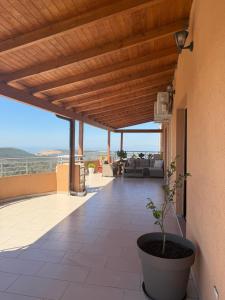 a porch of a house with a potted plant at Panoramic Krujë Escape BAMI in Krujë