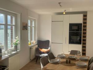 a living room with a dining room table and a chair at Haus Fährblick in Rees